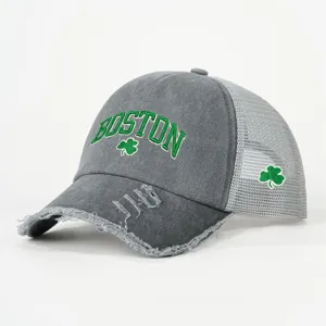 Distressed grey trucker hat with green Boston embroidery and clover motif for casual wear.