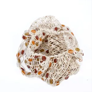 Woven mesh shoulder bag detail featuring colorful beads and hollow lattice design for beach style.