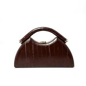 Brown eel pattern textured evening bag detail shot, vintage semi-circular handbag design.