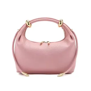 Pink leather handbag for women, chic drawstring shoulder bag with elegant gold hardware design.