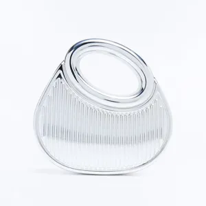 Silver metallic rigid evening bag detail, showing vertical striped texture and smooth ring handle.