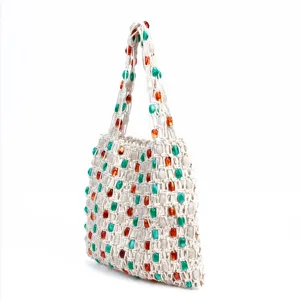 Detailed view of the handmade woven shoulder bag with colorful beads and hollow design.