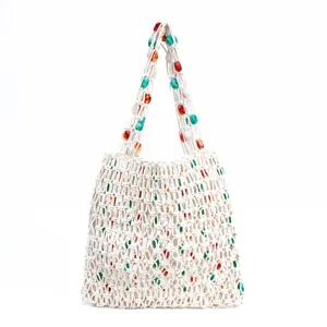Beige woven mesh shoulder bag with colorful beads, stylish hollow beach tote for women.