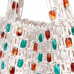 Beaded macrame knit handbag detail, cream woven mesh tote bag with colorful resin beads.