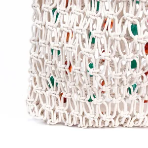 Handmade woven macrame bag detail, beige hollow mesh with colorful beads, summer style