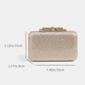 Close-up detail of sparkling rhinestone evening clutch bag with elegant crystal bow clasp decor.