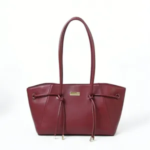 Retro burgundy trapezoid shoulder tote bag with double handles and stylish drawstring knot design.
