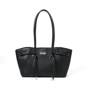 Detail view of a black leather shoulder tote bag with elegant handles and metal hardware.