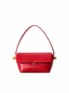 Detailed closeup of red leather shoulder bag, chic gold metal hardware accents, clasp.