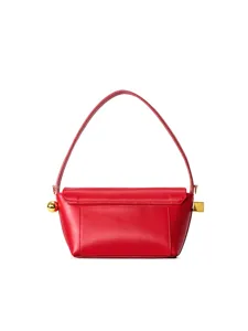 Red leather shoulder bag detail featuring elegant gold sphere and square lock hardware.