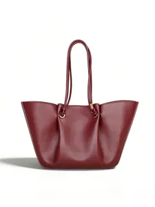 Burgundy slouchy leather tote bag detail, featuring pleated design and long knotted handle.