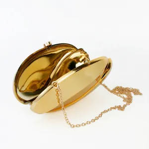Gold metallic acrylic wave clutch bag, detail view showing open structure and chain strap.