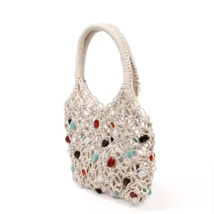Handcrafted woven mesh handbag featuring colorful decorative beads and a sturdy handle.