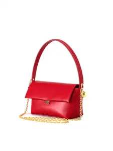 Red flap underarm bag detail view with gold chain strap and elegant top handle accessory.
