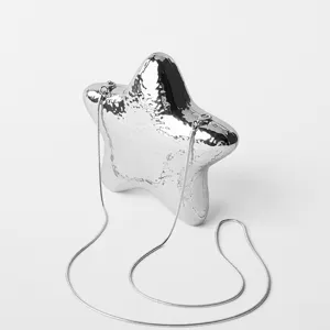 Silver metallic star shaped evening bag detail, glossy finish clutch with fine chain strap.