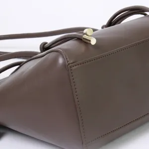 Retro brown shoulder bag for women, large capacity stylish handbag with metal closure detail.