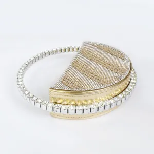 Sparkling rhinestone semi-circle evening handbag with circular handle for party events.