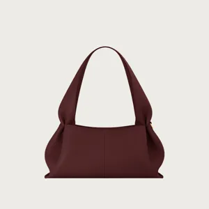 Minimalist leather shoulder bag, elegant underarm handbag with chic gathered dumpling shape.
