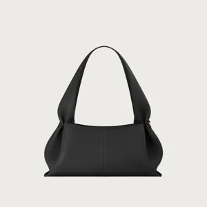Black leather shoulder bag featuring unique knotted handles and textured finish for everyday use
