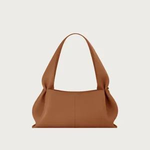 Brown leather shoulder bag detail, elegant knotted strap and dumpling shape design.