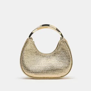 Gold metallic woven handbag detail, featuring unique crescent shape and curved metal handle.