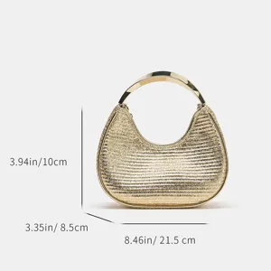 Detailed view of the metallic textured hobo handbag featuring a sleek curved metal top handle.