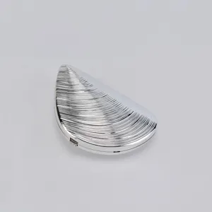 Silver metallic seashell evening clutch bag, unique shell shaped design for elegant parties.