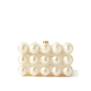 Elegant pearl acrylic clutch bag with golden clasp, stylish evening bag for women.