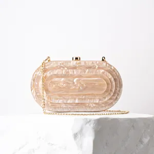 Elegant marble pattern acrylic oval evening clutch bag with gold chain detail, party accessory.