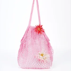 Detailed close-up view of the pink knit mesh beach tote bag with cute flower decor.