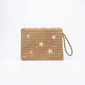 Woven straw clutch bag with colorful starfish and pearls, stylish summer beach shoulder bag.