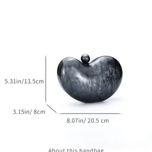 Detailed view of the acrylic marble bean evening clutch showing dimensions and unique shape.
