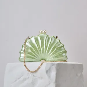 Pearl clasp and acrylic shell texture detail view of the elegant party clutch bag accessory.