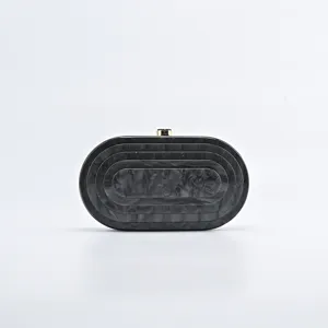 Black and white marble acrylic evening clutch detail showing unique oval striped pattern.