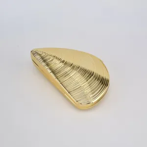Gold shell evening clutch bag, metallic acrylic material with textured ridges, elegant style.