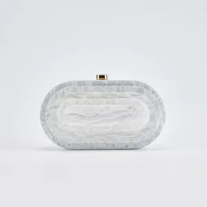 Detailed view of the elegant marble pattern acrylic evening clutch bag with gold tone clasp.