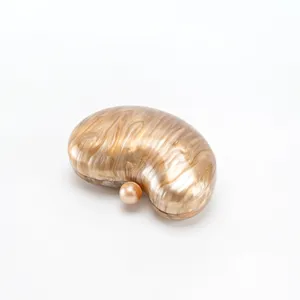Detailed view of the elegant bean-shaped acrylic evening clutch in glossy brown marble.