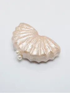 Pearl lustrous shell shaped acrylic evening clutch bag detail with twin pearl clasps.