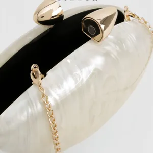 Elegant acrylic shell evening clutch bag with gold bullet clasp and detachable chain strap.