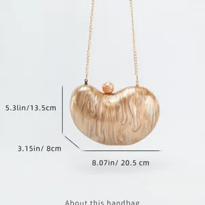 Acrylic bean clutch bag detail showing marble texture and gold chain strap craftsmanship.