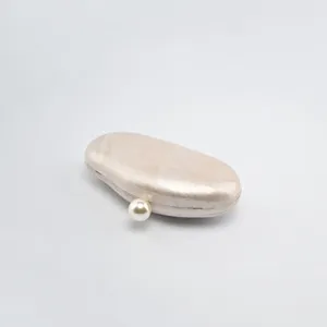 Beige acrylic clutch bag detail, elegant pearl clasp evening purse for women trendy.