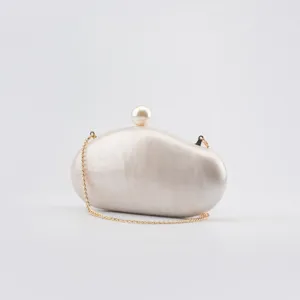Elegant marble acrylic clutch bag with pearl clasp and gold chain strap for women.