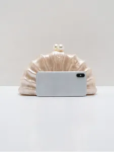 Elegant acrylic seashell clutch bag featuring pearl clasp, ideal for evening parties and events.