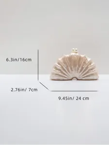 Pearl clasp acrylic seashell clutch detail view, showing exquisite marbled texture and size.