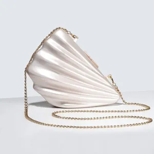 Pearl acrylic shell clutch bag detail showing exquisite texture and gold chain strap.