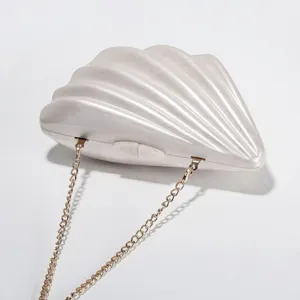 Elegant pearl white acrylic shell mini evening clutch bag with luxury gold chain.