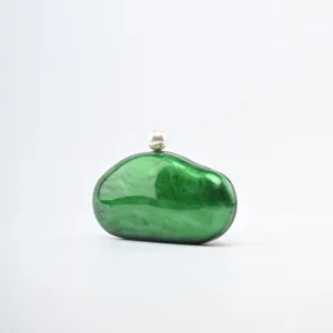 Green acrylic clutch bag with pearl clasp, stylish marble texture design for women evening party.