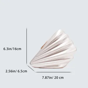 Detail view of the elegant shell acrylic clutch bag showing precise dimensions for buyers.