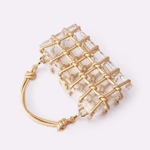 Clear acrylic box handbag featuring elegant gold rope knot weaving and metal clasp closure.