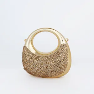Élégante pochette de soirée dorée en cristal avec poignée ronde pour fête et mariage.